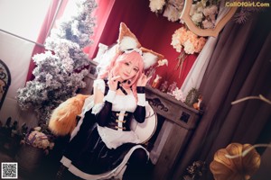 A woman dressed as a fox holding a rose in her hand.