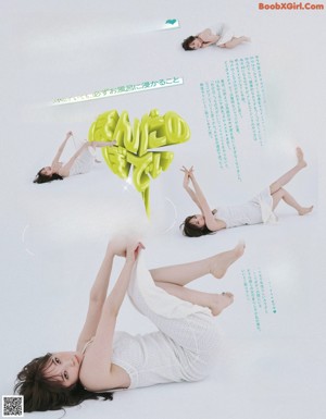 A woman in a white shirt is posing for a magazine.