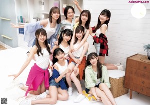 A group of young women in school uniforms posing for a picture.