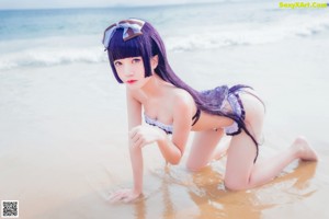 A woman with purple hair and a bow on her head.