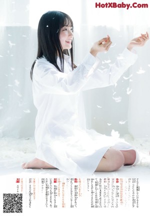 A woman in a white shirt is posing for a picture.