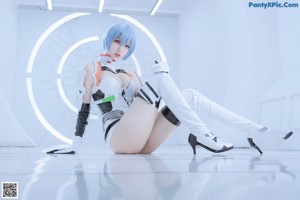 A woman in a white and black outfit holding a white robot.