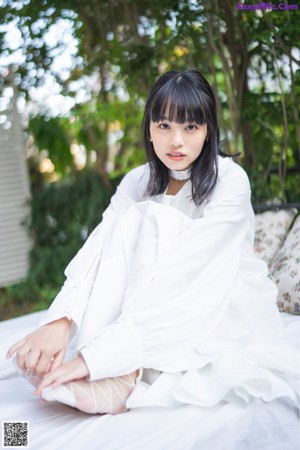 A woman sitting on top of a wooden table.