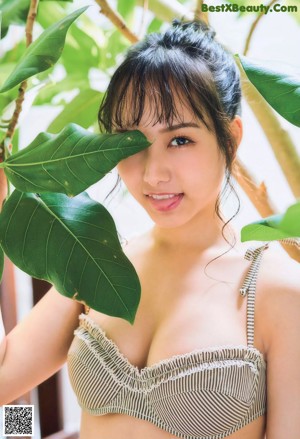 A woman in a yellow bikini posing for a magazine.