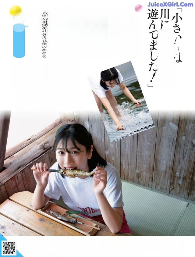 A woman sitting at a table eating a piece of food.