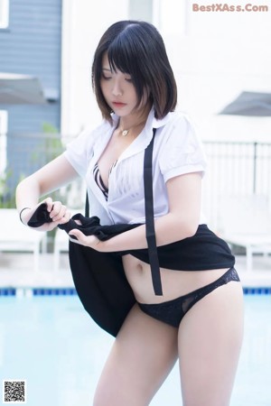 A woman wearing a white shirt and black skirt.