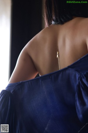 A naked woman laying on top of a wooden table.