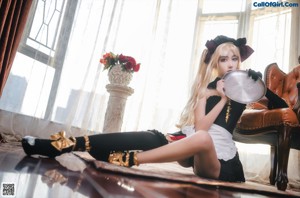 A woman sitting on top of a brown couch.