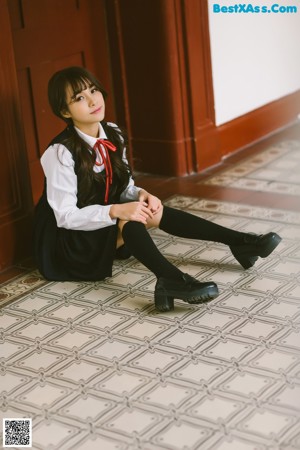 A woman in a school uniform posing for a picture.