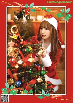 A woman in a santa claus outfit sitting on a window sill.